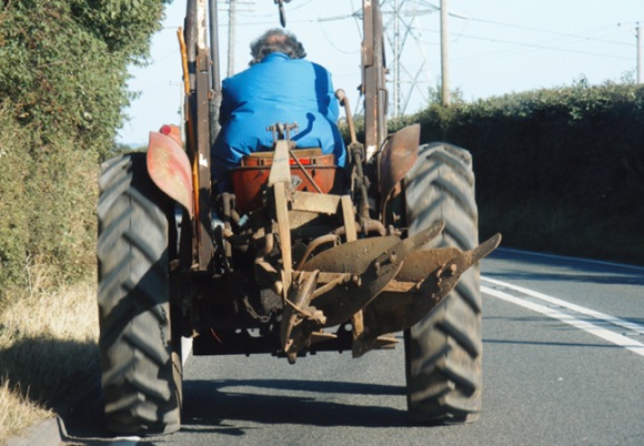 A tractor on a country road.